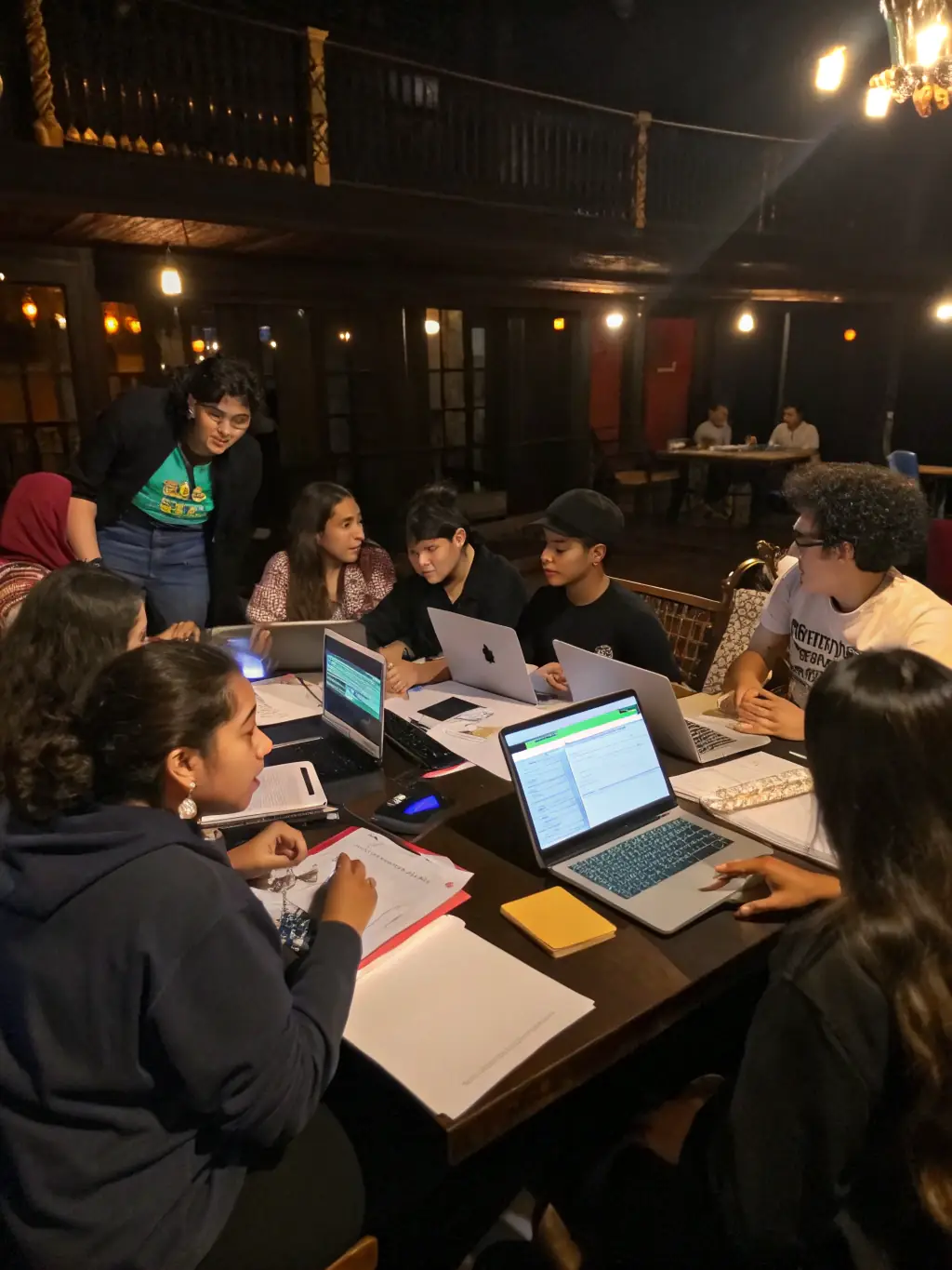 A photograph capturing a lively scene from a youth leadership workshop, showcasing young participants actively engaged in a group discussion, with facilitators guiding them. The setting is bright and modern, reflecting a collaborative learning environment.